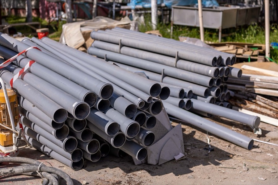 Stacked grey PVC plumbing pipes